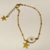 Noa: Bracelet doré avec un médaillon blanc et une étoile