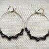 Perle: Boucles d'oreilles créoles argentées perles en verre noires.